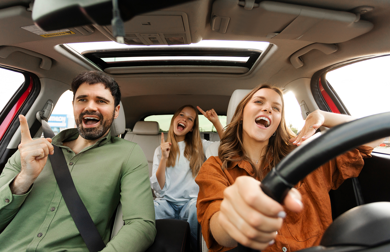Happy people in car needing roadside assistance